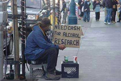 A Veteran sits on the street waiting for handouts for "Alcohol Research"